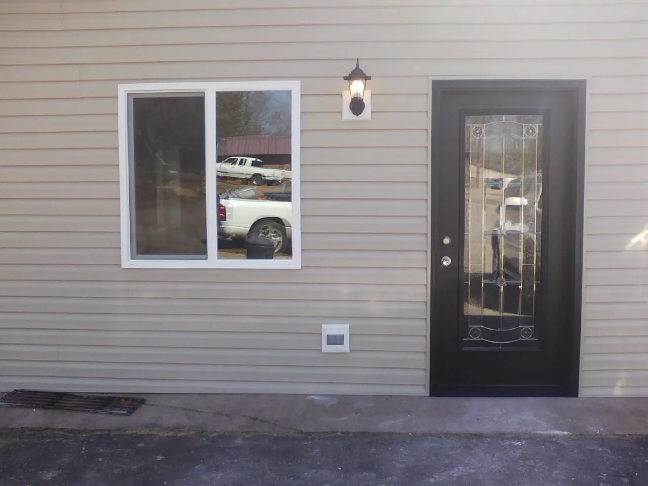 New siding, window and entry door on the side of an addition in Conesville